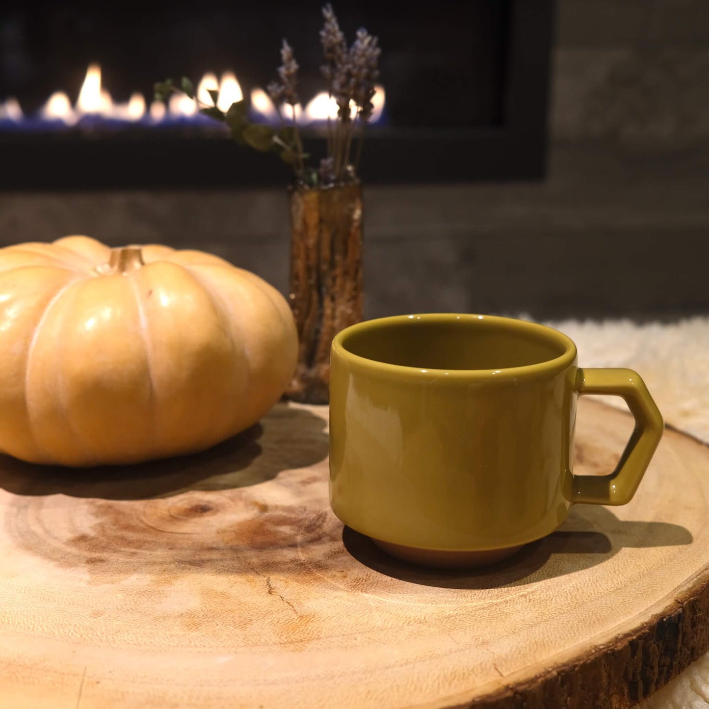 Side view of chips mug in mustard with fireplace background.