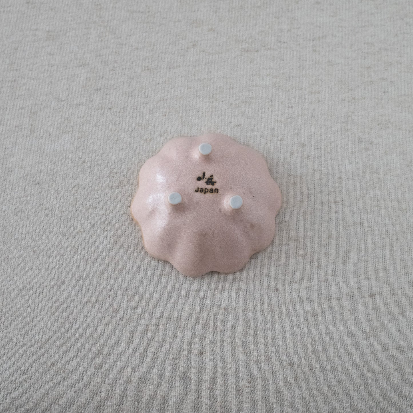 Bottom view of a pink Rinka Bowl by Kaneko Kohyo, showcasing its elegant ceramic craftsmanship and signature design.