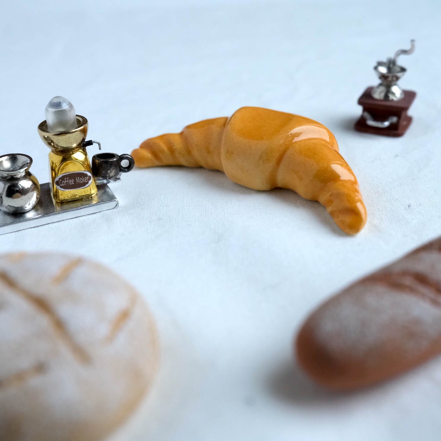 Croissant chopstick holder with tiny coffee decorations.