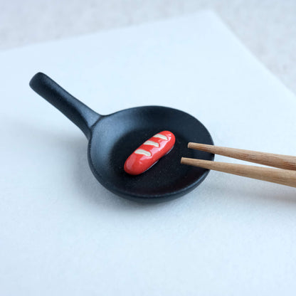 Frying Pan with Sausage Chopstick Rest