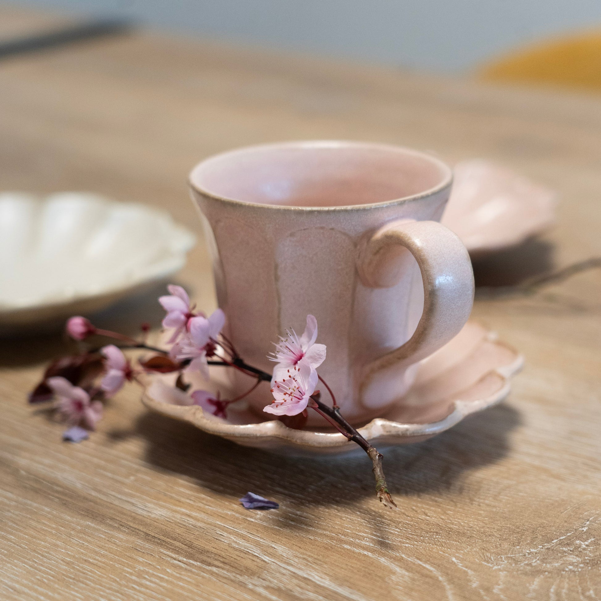 Elegant handcrafted pink coffee mug with saucer made in Japan - Side view