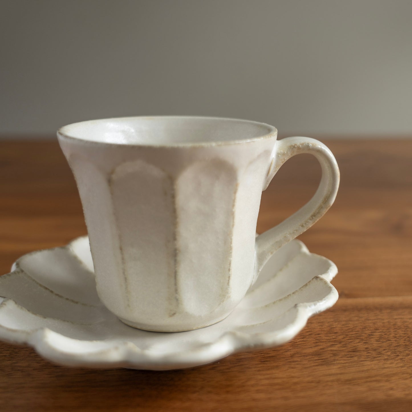 Elegant handcrafted white coffee mug with saucer made in Japan - Side view