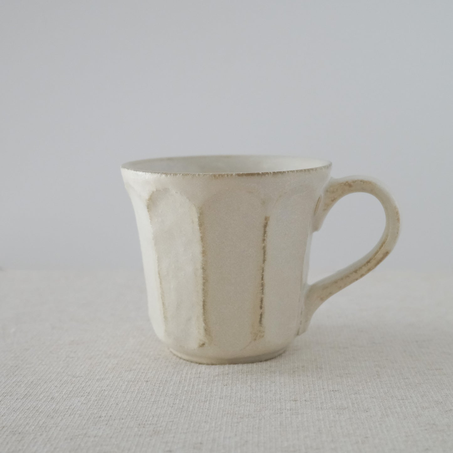 Elegant handcrafted white coffee mug made in Japan - Side view